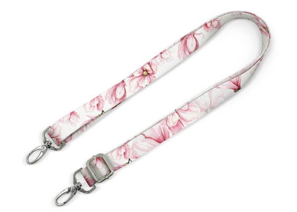 A custom bag strap with a sublimation print featuring pink flowers. Adjustable length and durable hardware. An ideal promotional accessory. AMGS Group.