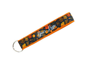 Short stitched keychain with an orange bottom strap and a top layer featuring sublimation print. A practical promotional gadget, perfect for promotional agencies and marketing teams. Available at AMGS Group.