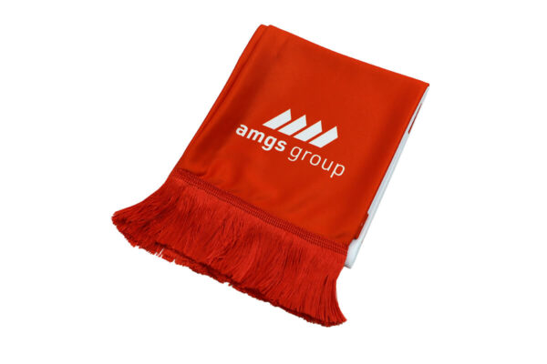 Red branded AMGS Group scarf with white logo and tassels, shown in close-up.
