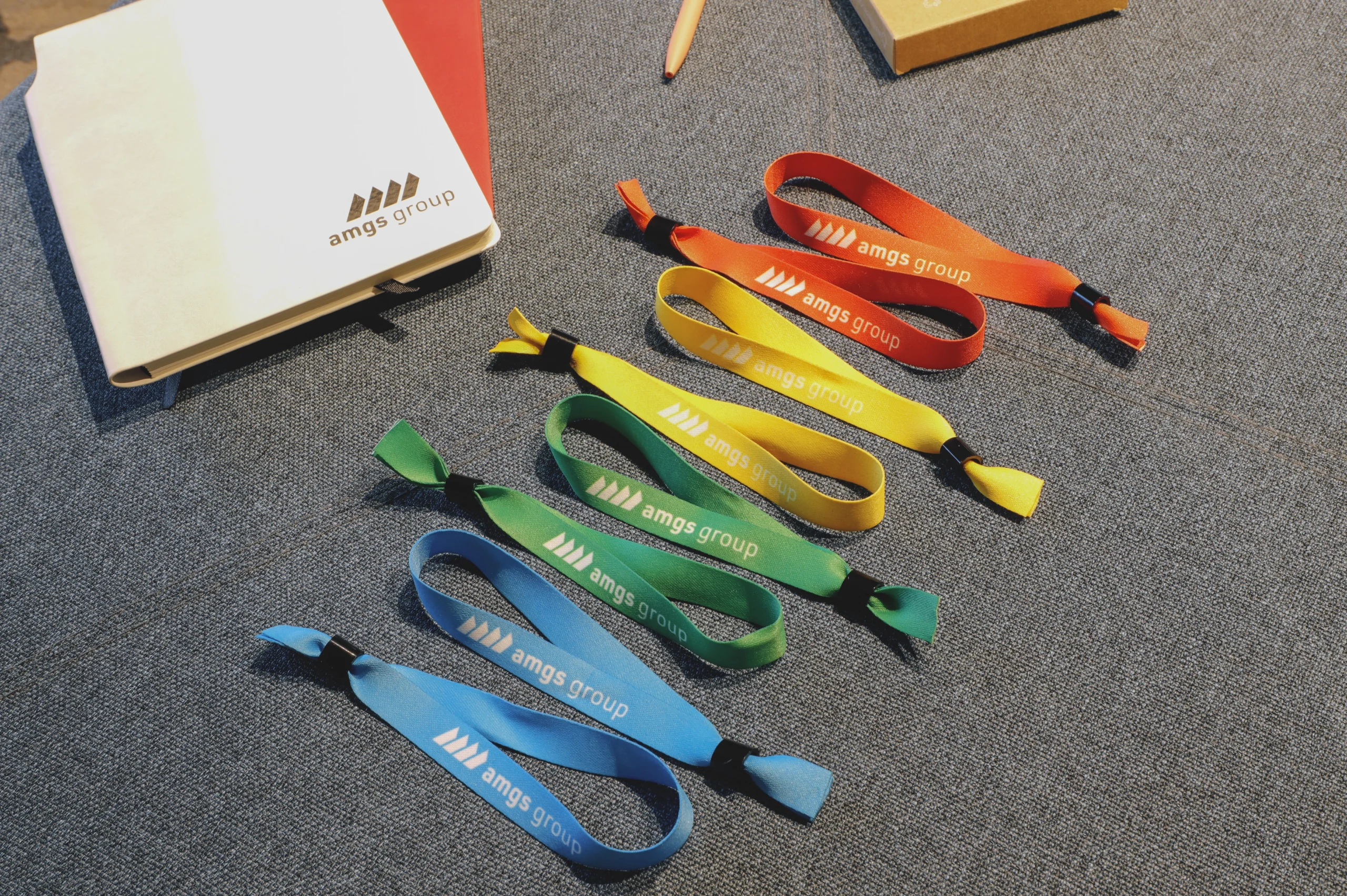 Colourful promotional lanyards and silicone wristbands from own production in AMGS Group factory.