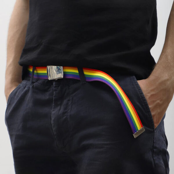 Model wearing branded rainbow belt with sublimated logo as part of a casual outfit.