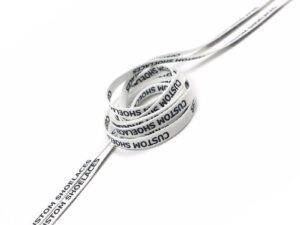 White tubular shoelaces with repeating black 'Custom Shoelaces' text printed.