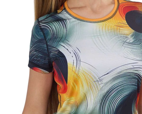 Close-up of the womens sublimated sports t-shirt with a bold, abstract print in shades of orange, red, black, and green. Design your own version with AMGS Group and stand out during your workout!
