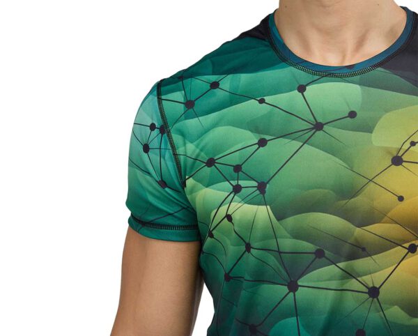 Close-up of a men’s sports T-shirt with dynamic sublimation print – a multicolor gradient in shades of green, yellow, and navy blue, featuring a graphic mesh connection pattern. Breathable fabric and neat finishes ensure comfort and a modern look. Available at AMGS Group.