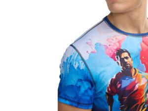 Close-up of the men’s Sport Thermoactive Smooth T-shirt with a vivid, colorful print depicting a silhouette of a running man against blue and red paint splashes. Made of thermoactive, elastic fabric with precise sleeve stitching. Available at AMGS Group.