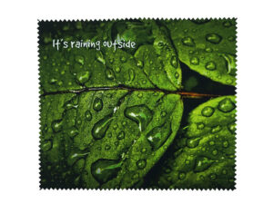 Microfiber cloth with photographic print showing a green leaf with raindrops – unique promotional item by AMGS Group.